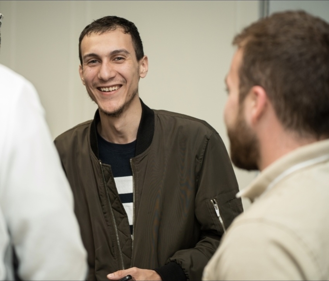 A New Muslim brother smiling at a community gathering