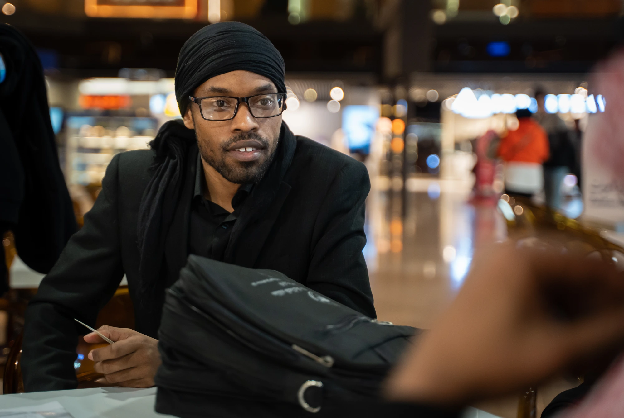 Cyrus listening during a transit stop at Jordan Airport