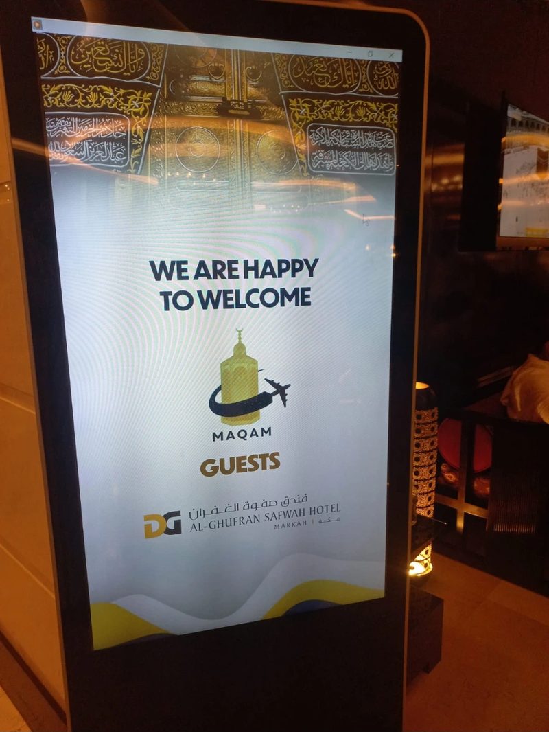 A Makkah hotel's digital display welcoming New Muslim Umrah guests