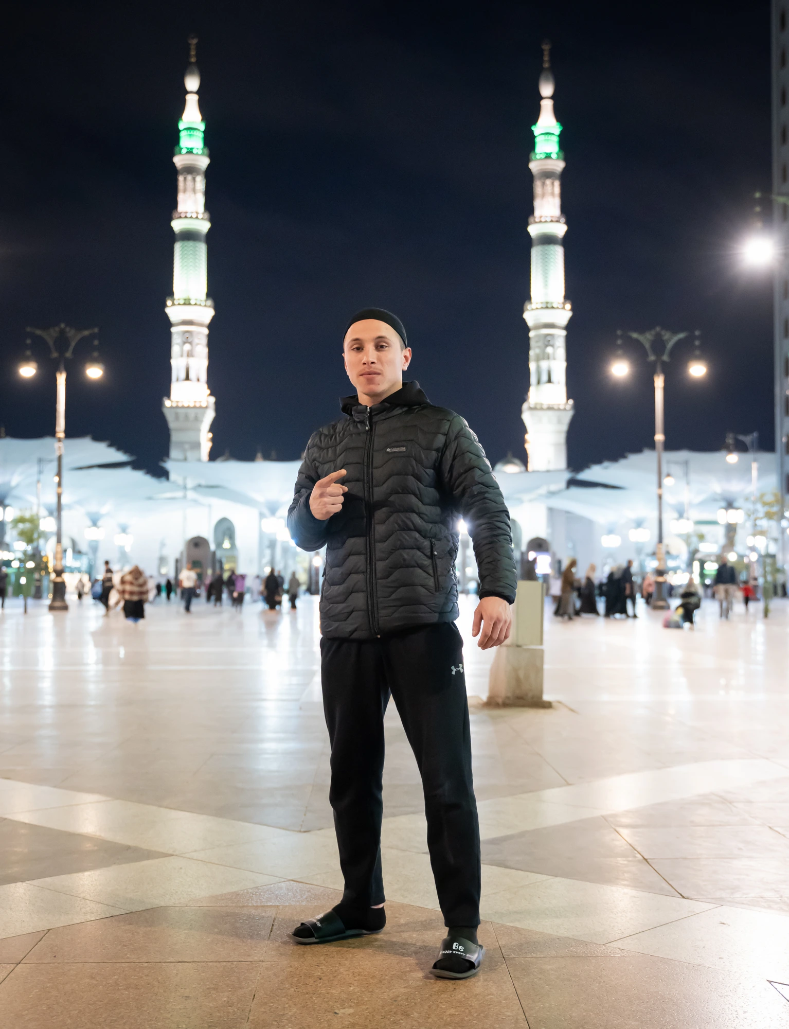 A brother from a past journey between the minarets of Masjid an-Nabawi at night
