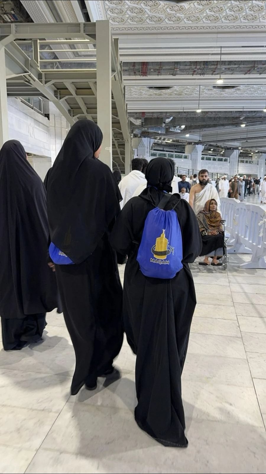 Sisters of a past journey with their Umrah bags inside the Haram